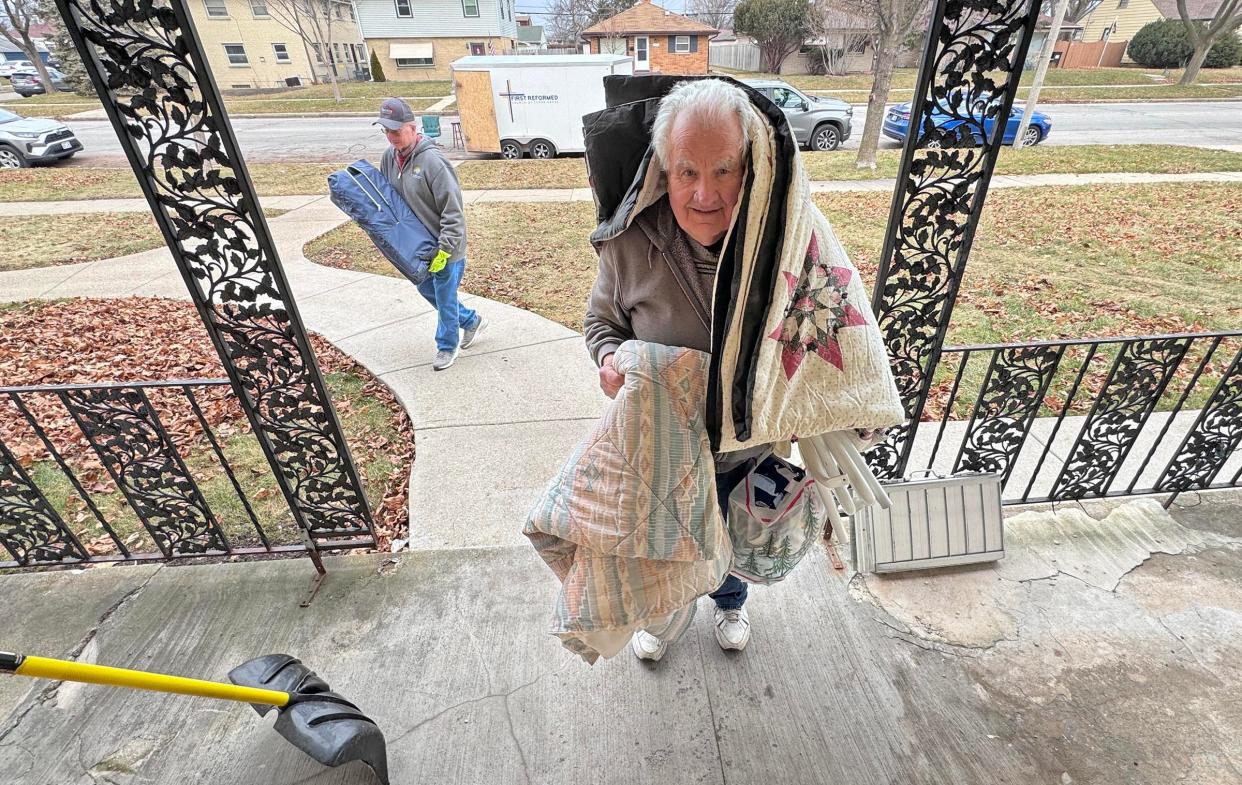 Lloyd Ter Maat carries in a load of handmade quilts, made by a member of his Cedar Grove congregation, First Reformed Church, to an individual to be donated to on West Congress Street in Milwaukee on Friday, Jan. 5, 2024. For more than 30 years, Lloyd’s Trailer Ministry has been making deliveries of donated furniture from Sheboygan County to Milwaukee 2-3 times a week.