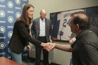 Catie Griggs, left, talks to the press after being introduced as the Seattle Mariners' new president of business operations during a baseball a press conference on Wednesday, July 28, 2021, (AP Photo/Jason Redmond)