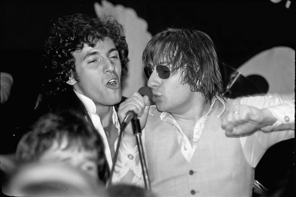 Bruce and Southside Johnny share a microphone during a 1977 concert