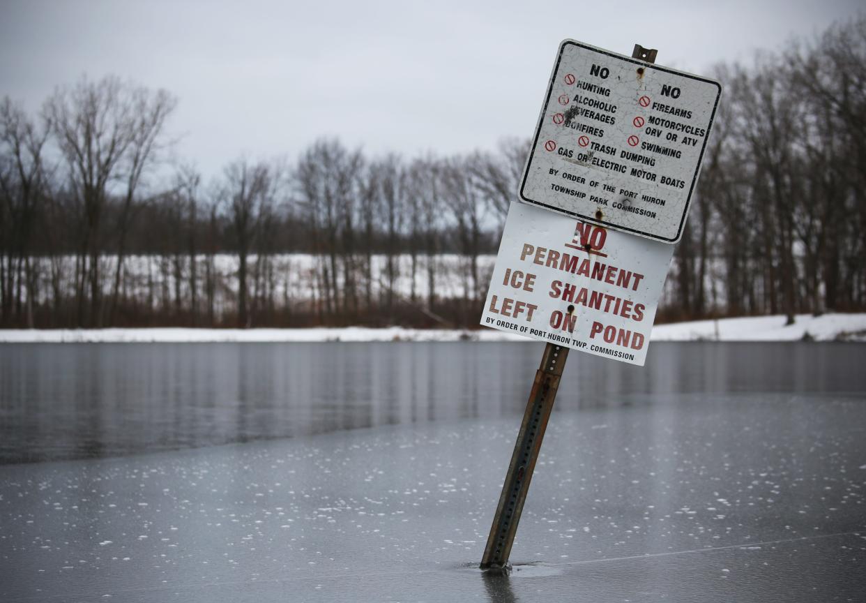 Ice forms around a warning sign for ice fishers not to leave permanent ice shanties on the pond on Wednesday, Jan.5, 2022, at the 40th Street Pond in the William P. Thompson Park.