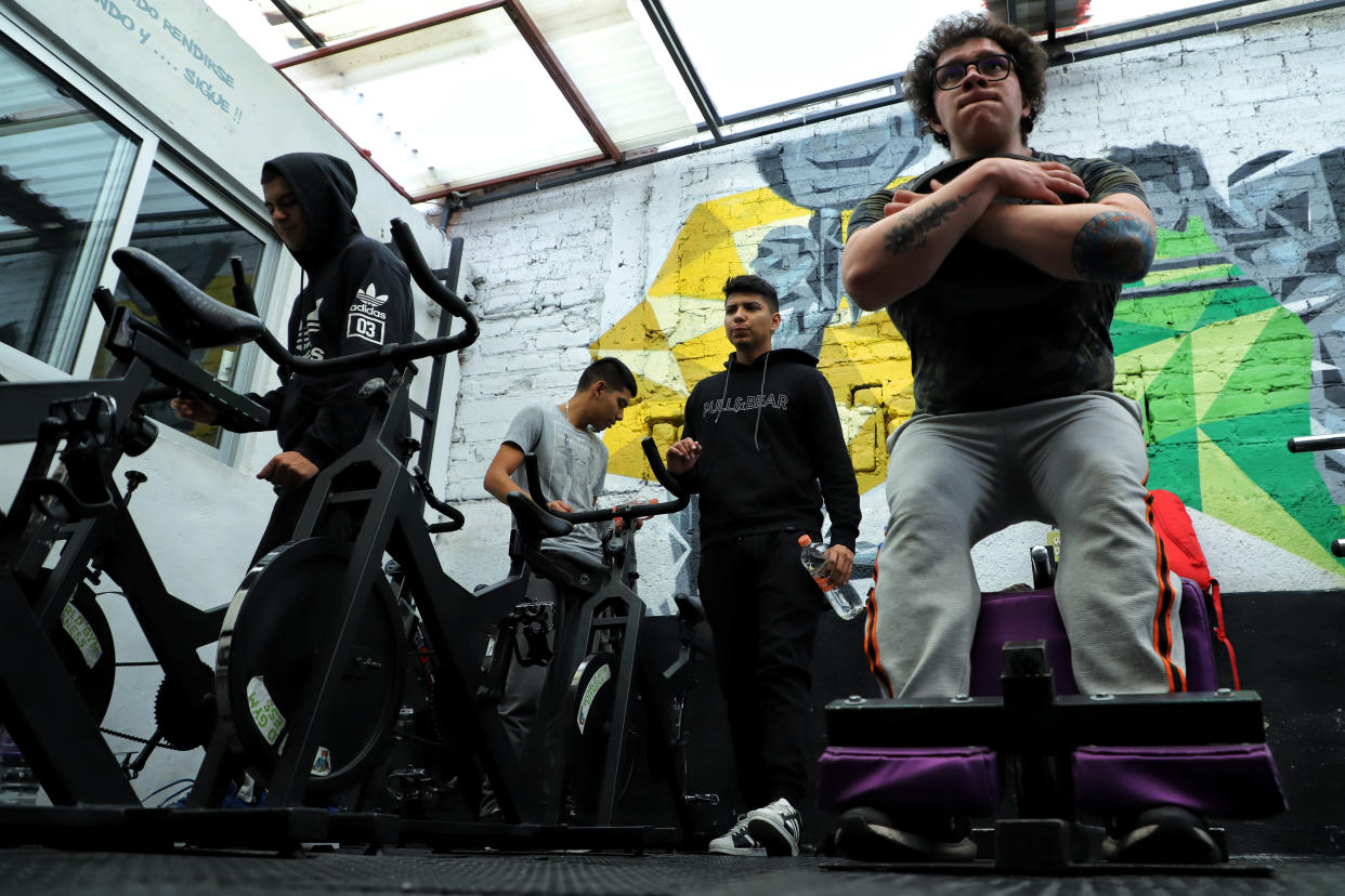 MEXICO CITY, MEXICO - JULY 25: People train in a gym behind closed doors as official reopening will be allowed Monday July 27th on July 25, 2020 in Mexico City, Mexico. While most of the Mexican States remain in red color level, some activities considered non essential are now allowed by the government and the 'new normal' is gradually assimilated by society.   (Photo by Héctor Alfaro/Agencia Press South/Getty Images)