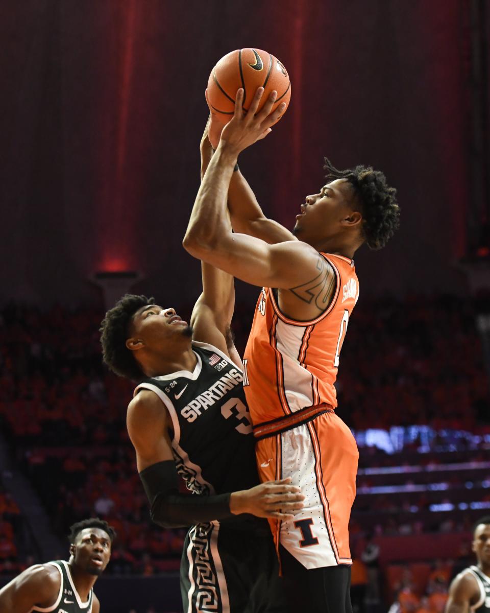 Illinois' Terrence Shannon Jr., right, shoots as Michigan State's Jaden Akins (3) defends during the first half of an NCAA college basketball game, Friday, Jan. 13, 2023, in Champaign, Ill.