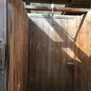 <p>The tent even has little camping luxuries, like this cedar outdoor shower. (Airbnb) </p>