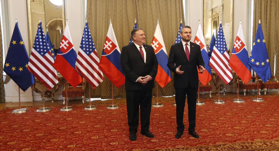 Slovakia's Prime Minister Peter Pellegrini, right, welcomes US Secretary of State Mike Pompeo, during his visit to Bratislava, Slovakia, Tuesday, Feb. 12, 2019. Pompeo is in Slovakia on the second leg of a five-nation European tour that began in Hungary and will take him to Poland, Belgium and Iceland. (AP Photo/Petr David Josek)