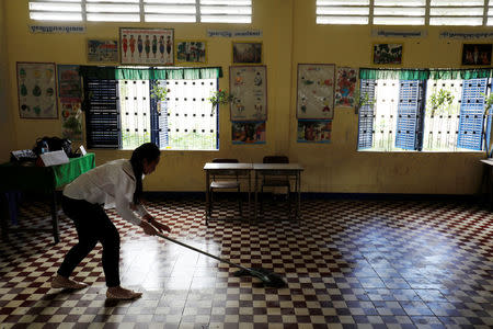 An election worker cleans a classroom that will be used as a polling site before the arrival of election materials at a school in Phnom Penh, Cambodia, July 28, 2018. REUTERS/Darren Whiteside
