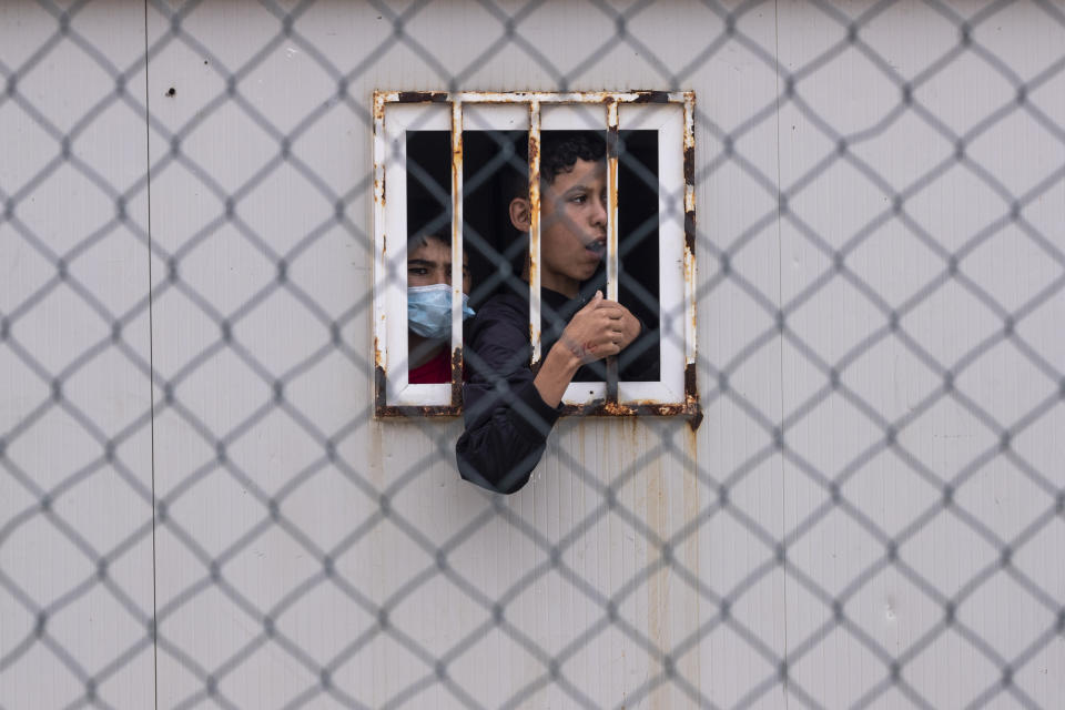 Children who crossed into Spain wait inside a temporary shelter for unaccompanied minors in the enclave of Ceuta, next to the border of Morocco and Spain, Thursday, May 20, 2021. (AP Photo/Bernat Armangue)