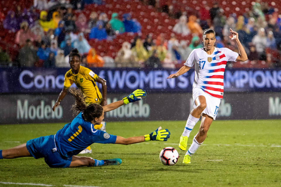 Oct 14, 2018; Frisco, TX, USA; Jamaica goalkeeper Sydney Schneider (1) and United States forward Tobin Heath (17) in action during the game in a 2018 CONCACAF Women's Championship soccer match at Toyota Stadium. Mandatory Credit: Jerome Miron-USA TODAY Sports