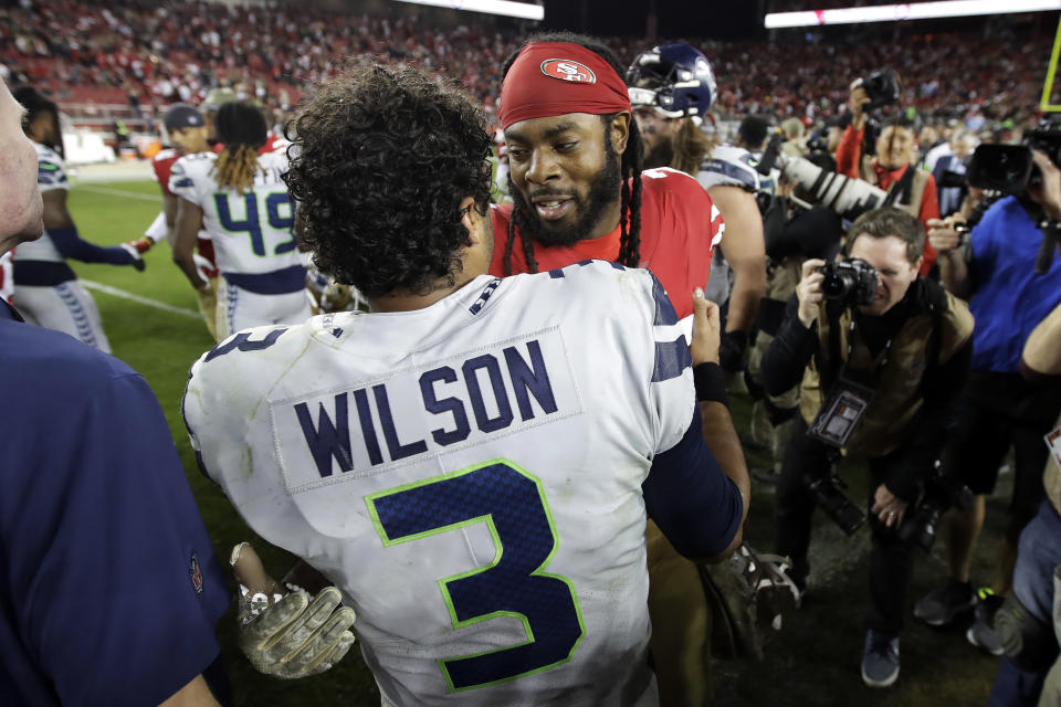 Seattle Seahawks quarterback Russell Wilson (3) greets San Francisco 49ers cornerback Richard Sherman after an NFL football game in Santa Clara, Calif., Monday, Nov. 11, 2019. The Seahawks won 27-24 in overtime. (AP Photo/Ben Margot)