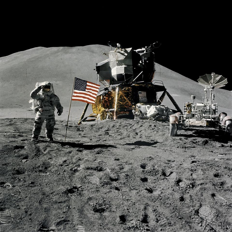 Astronaut James Irwin, lunar module pilot, gives a military salute while standing beside the U.S. flag during Apollo 15 lunar surface extravehicular activity (EVA) at the Hadley-Apennine landing site on the moon, August 1, 1971.