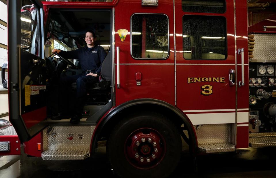 Stephanie Johnson, a 10-year veteran of the Providence Fire Department, always volunteers to work on Christmas Day. She is sitting in Engine 3, which she often drives at the Washington Street station.