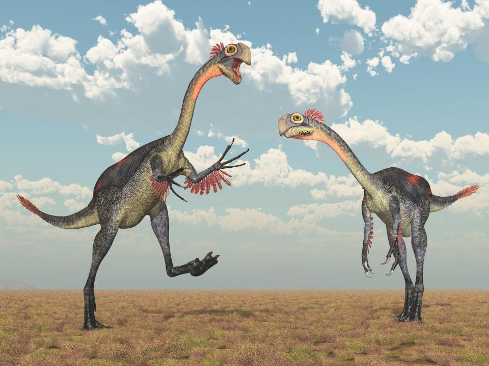 A 3D rendering of an artist's impression of two gigantoraptors, beaked dinosaurs with clawed hands and feathers.