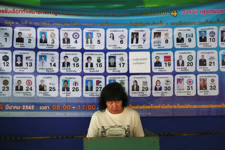 A voter stands in a ballot booth during the general election at a polling station in Bangkok, Thailand, March 24, 2019. REUTERS/Athit Perawongmetha
