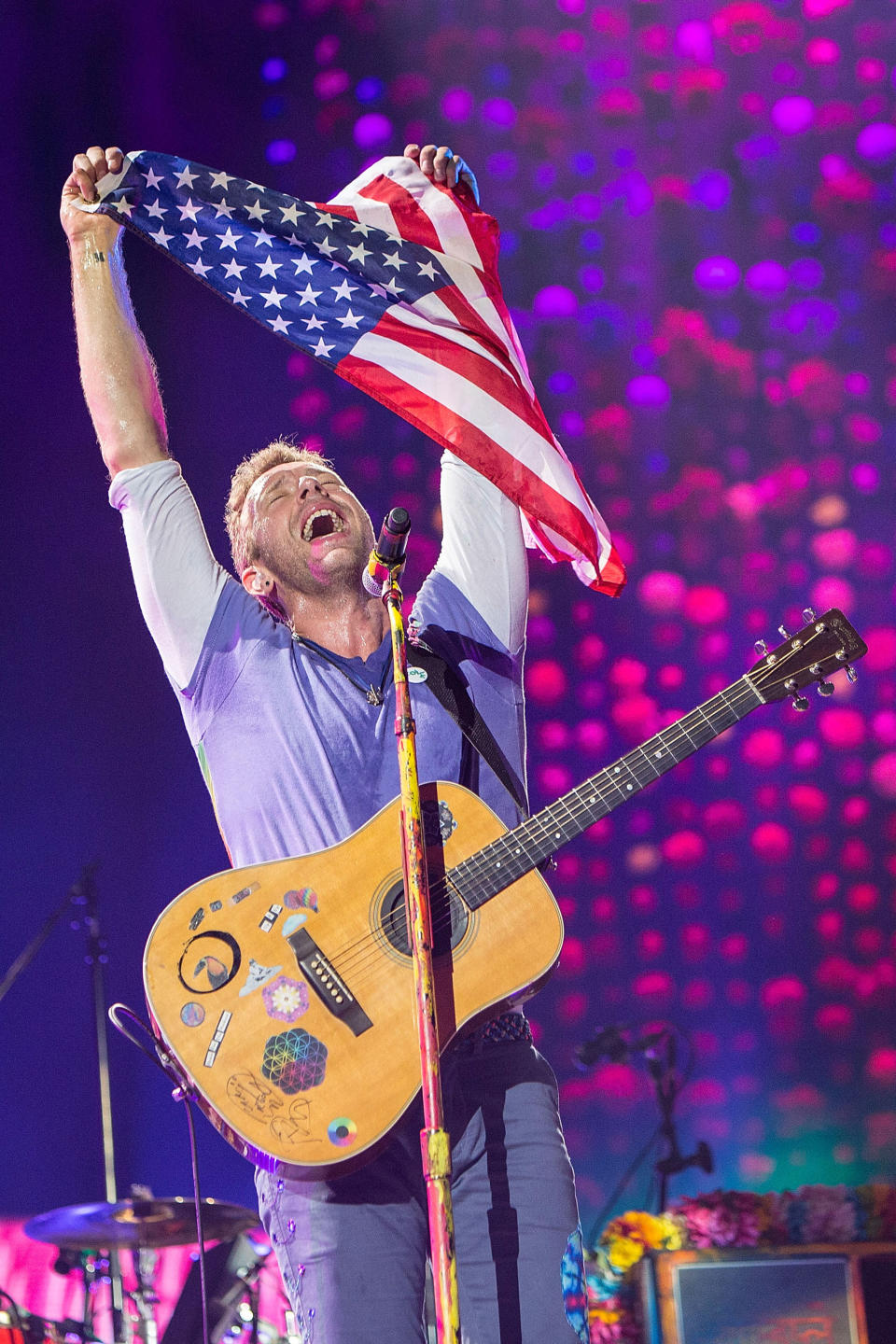 <p>In San Diego, the Coldplay frontman held up the U.S. flag during a concert. The Friday edition of that same show featured an appearance by late night host James Corden, who joined the band in a rendition of “Free Fallin” by the late Tom Petty, one of many tributes since Petty’s Oct. 2 death. (Photo: Daniel Knighton/Getty Images) </p>