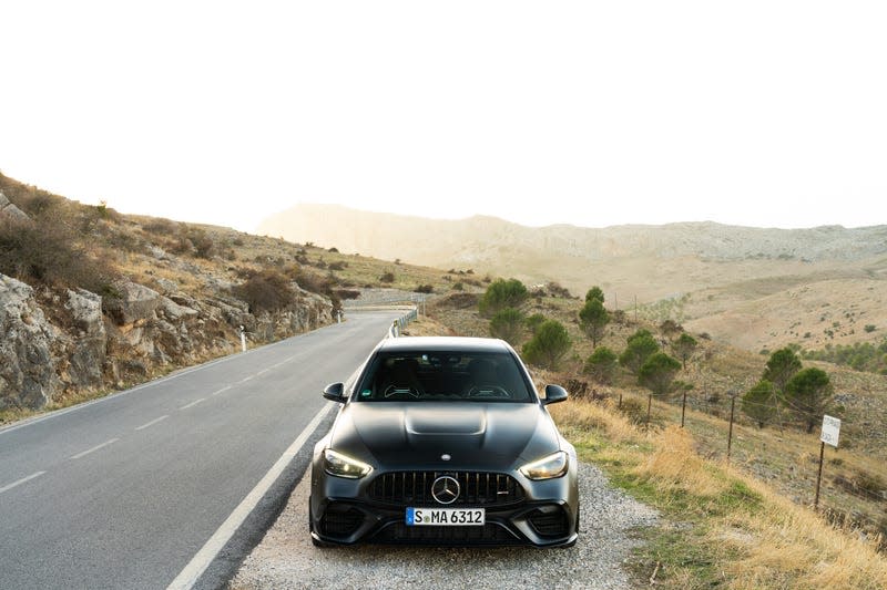 2023 mercedes-amg c 63 s e-performance in matte black photographed on the side of a mountain road in spain