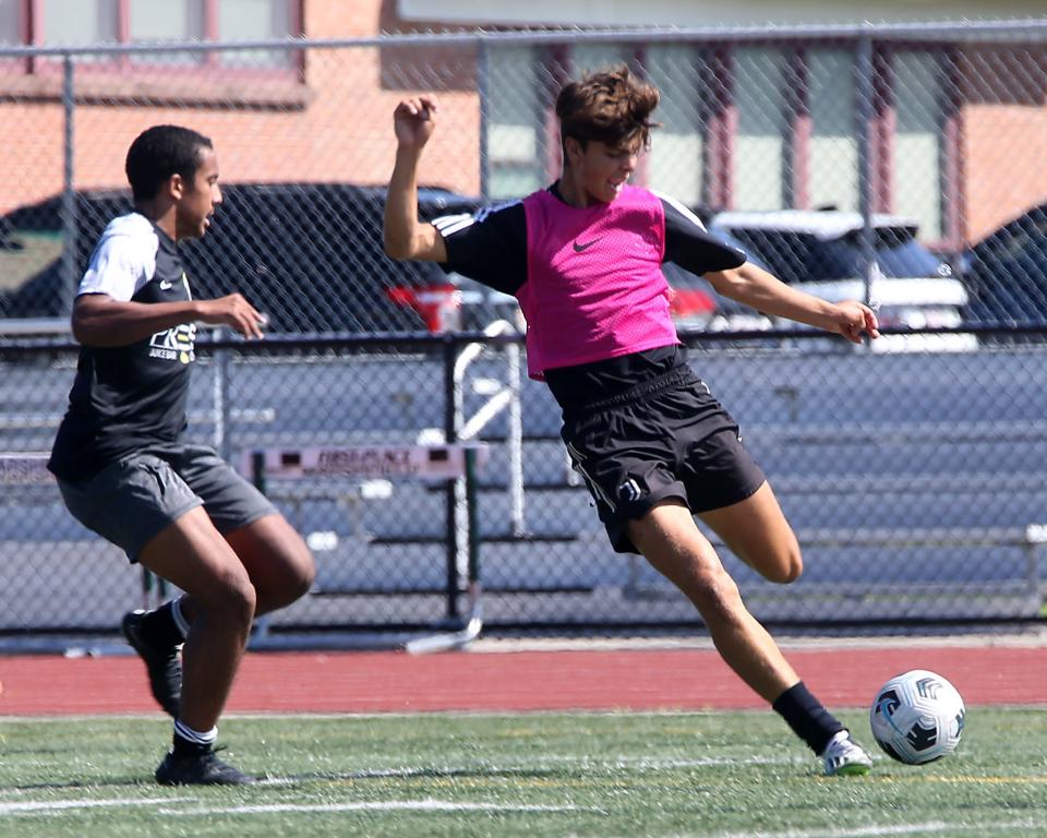 Senior Kaden Puglia looks to cross the ball while going on the attack during a scrimmage at boys soccer practice at Marshfield High on Wednesday, Aug. 23, 2023.