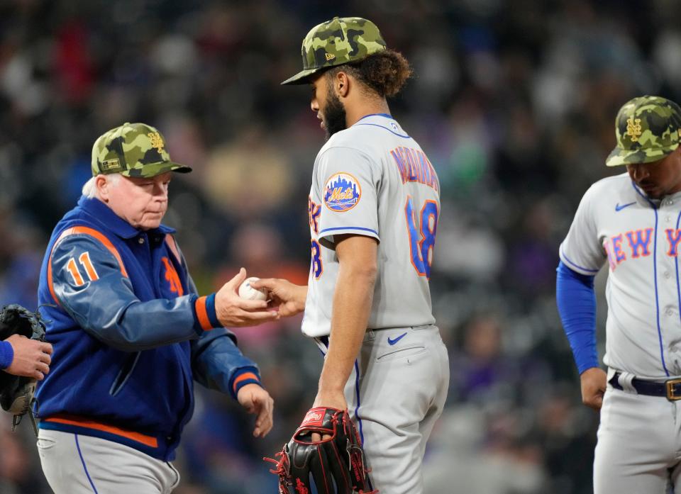 New York Mets manager Buck Showalter, left, takes the ball from relief pitcher Adonis Medina as Medina is pulled from the mound after giving up a double to Colorado Rockies' Connor Joe in the sixth inning of the second baseball game of a doubleheader Saturday, May 21 2022, in Denver.