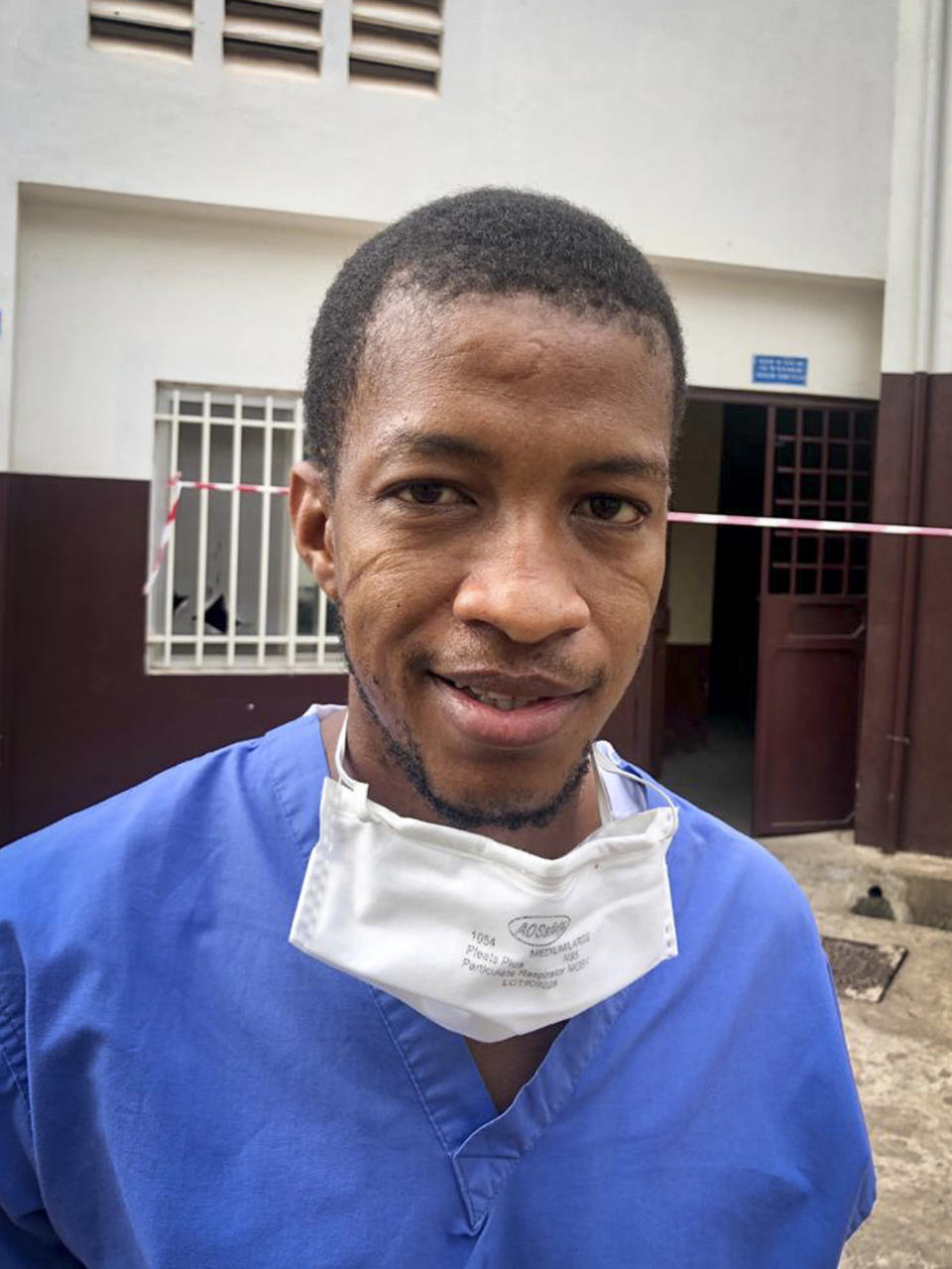 In this undated handout photo provided by Dr. Mamadu Baldeh, Baldeh, one of only four physicians managing the COVID-19 unit and the only one doing so while still overseeing the infectious diseases unit, is photographed outside the Connaught Hospital where he works in the capital Freetown, Sierra Leone in 2020. Despite the loss of colleagues, Baldeh is fighting not only to save his coronavirus patients but also to provide quality care for those afflicted with other infectious diseases as he and other health care workers fight for a better system. (Dr. Mamadu Baldeh via AP)