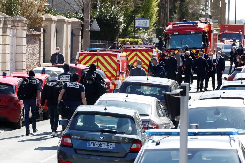 Police secure the area where an attacker stabbed a woman, in Rambouillet