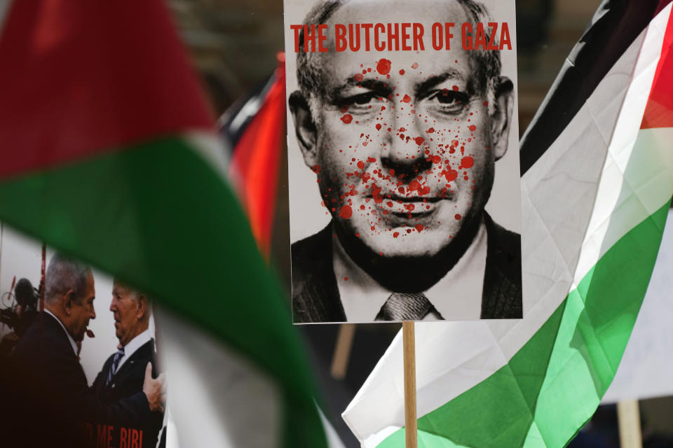 FILE - Posters showing Israel's Prime Minister Benjamin Netanyahu and U.S. President Joe Biden are carried among Palestinian flags during a pro-Palestinian rally in Sydney, Oct. 21, 2023. Australian government named a special envoy Tuesday, July 9, 2024 to confront a rise in antisemitism across the country since the Israel-Hamas war began. A similar envoy will soon be appointed to challenge Islamophobia in Australia and both will promote social cohesion, Prime Minister Anthony Albanese told reporters at the Sydney Jewish Museum. (AP Photo/Rick Rycroft, File)