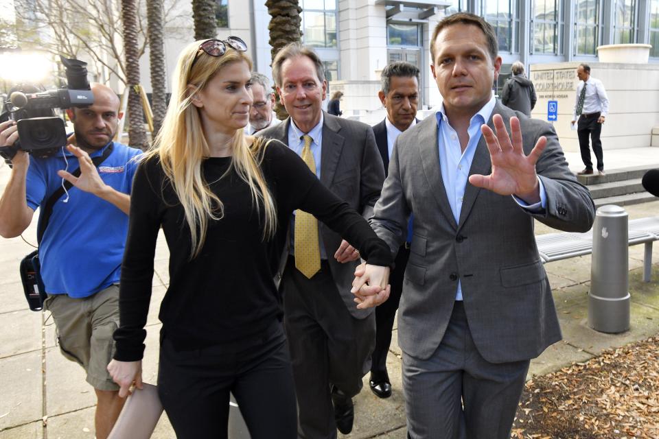 Former JEA CEO Aaron Zahn with his wife and attorney, Brian Albritton, leave the Federal Courthouse after Zahn posted bond on Tuesday, March 8.