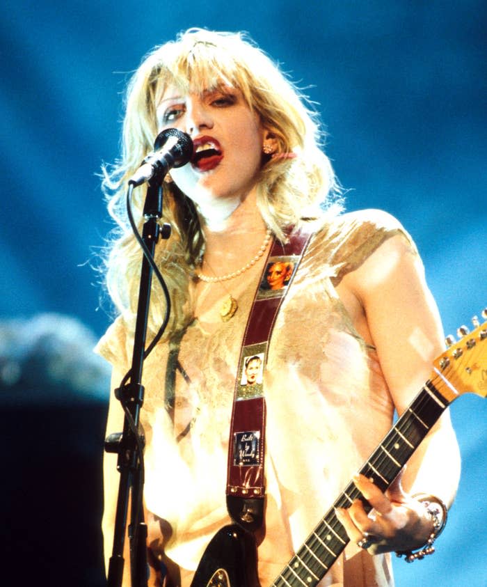 Courtney Love with playing the guitar and singing  on stage