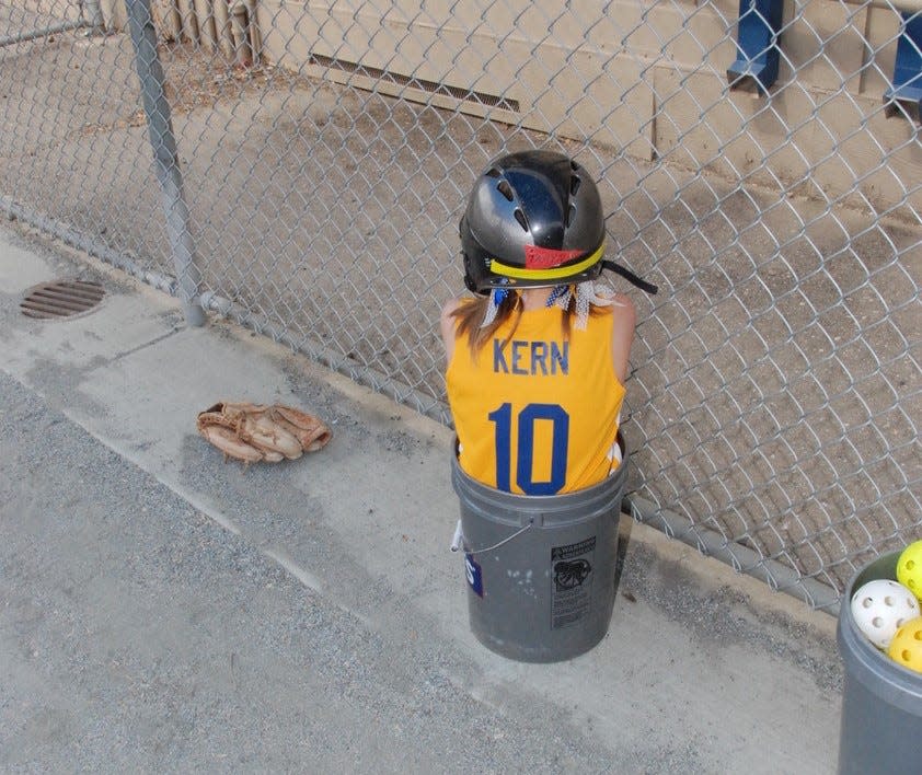 Taryn Kern sitting in the bucket after a strike out in 8U.