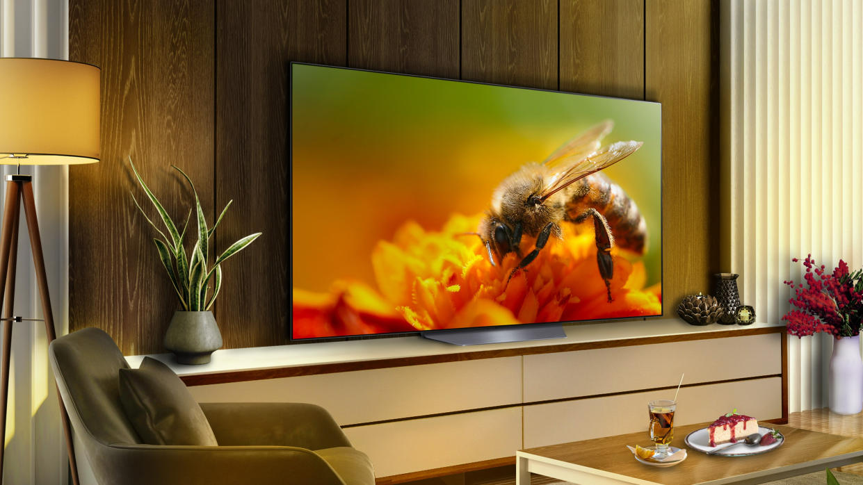  LG B3 OLED TV in a modern apartment living room with a bee on screen. 