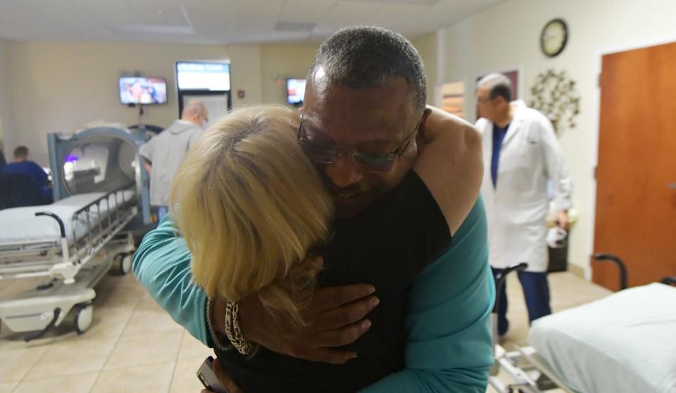 Veteran Anthony Scaife, a participant of The 22 Project, gets a hug from nurse Laura Mastrony at Hyperbaric Service for the Palm Beaches on Friday, May 20, 2022 in Delray Beach.