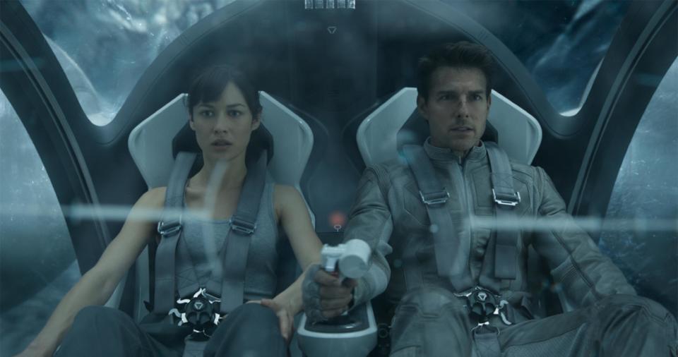 This film publicity image released by Universal Pictures shows Olga Kurylenko, left, and Tom Cruise in a scene from "Oblivion." (AP Photo/Universal Pictures)