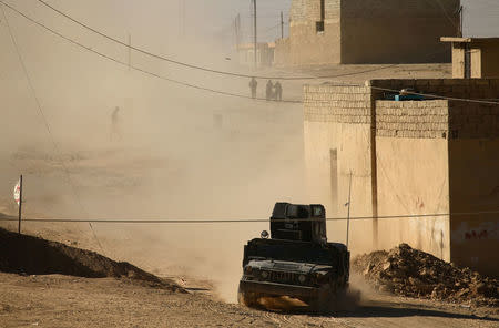 A military vehicle of Iraqi special forces drives during a battle with Islamic State militants in Mosul, Iraq November 22, 2016. REUTERS/Thaier Al-Sudani