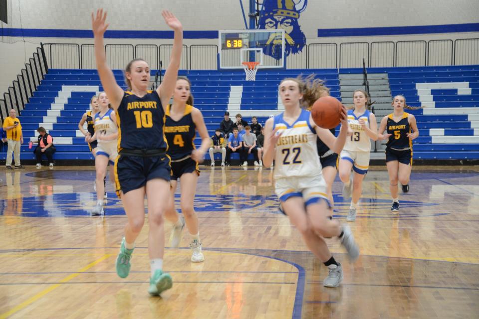 MacKenzie LaRoy of Ida goes to the basket against Airport's RaeAnn Drummond during the finals of the Division 2 District at Dundee Saturday.
