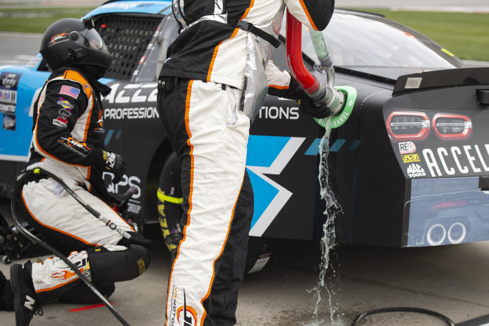 A pit crew works on Sam Mayer's car during a NASCAR Xfinity Series auto race at Atlanta Motor Speedway on Saturday, March 18, 2023, in Hampton, Ga. (AP Photo/Hakim Wright Sr.)