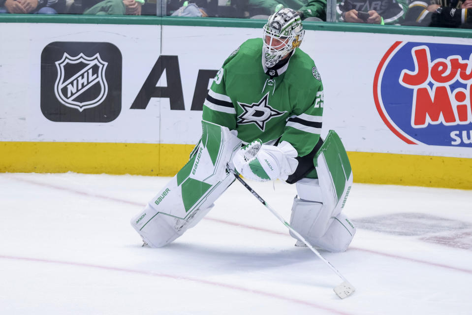 Dallas Stars goalie Jake Oettinger looks to pass the puck during the third period of Game 4 of the team's NHL hockey Stanley Cup Western Conference finals against the Vegas Golden Knights on Thursday, May 25, 2023, in Dallas. (AP Photo/Gareth Patterson)