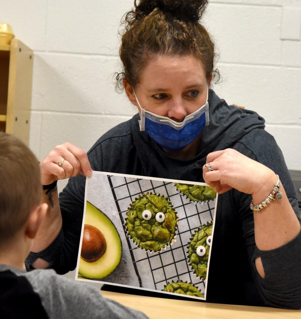 Monroe Family YMCA Youth Outreach Director Carrie Powell shows a photo of the monster green avocado, turkey and egg bites that the preschoolers were going to make.