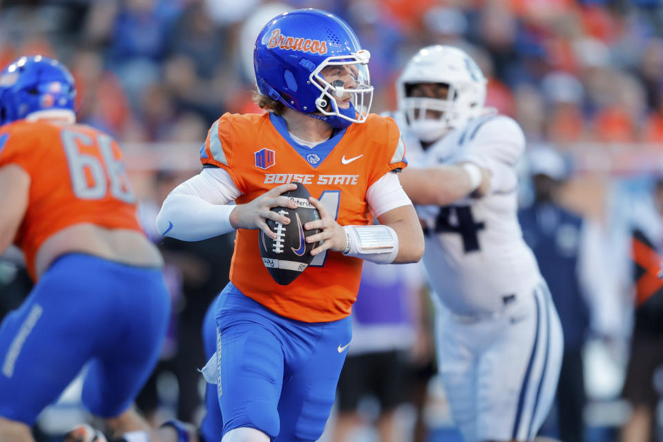 Boise State quarterback Maddux Madsen (4) looks down field against Utah State in the first half of an NCAA college football game, Saturday, Oct. 5, 2024, in Boise, Idaho. . (AP Photo/Steve Conner)