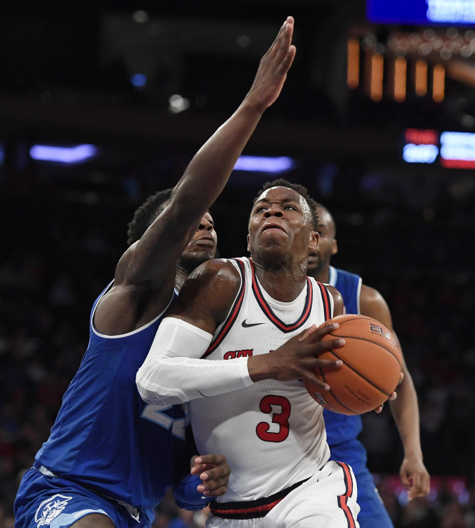 St. John's guard Rasheem Dunn (3) drives toward the basket against Seton Hall guard Myles Cale (22) during the second half of an NCAA basketball game in New York, Saturday, Jan. 18, 2020. (AP Photo/Sarah Stier)