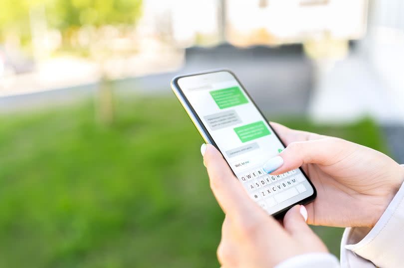 Texting sms with phone in city outdoor park. Woman sending text message with cellphone. Chatting on instant messaging app. Person using smartphone. Conversation and discussion with friend online.