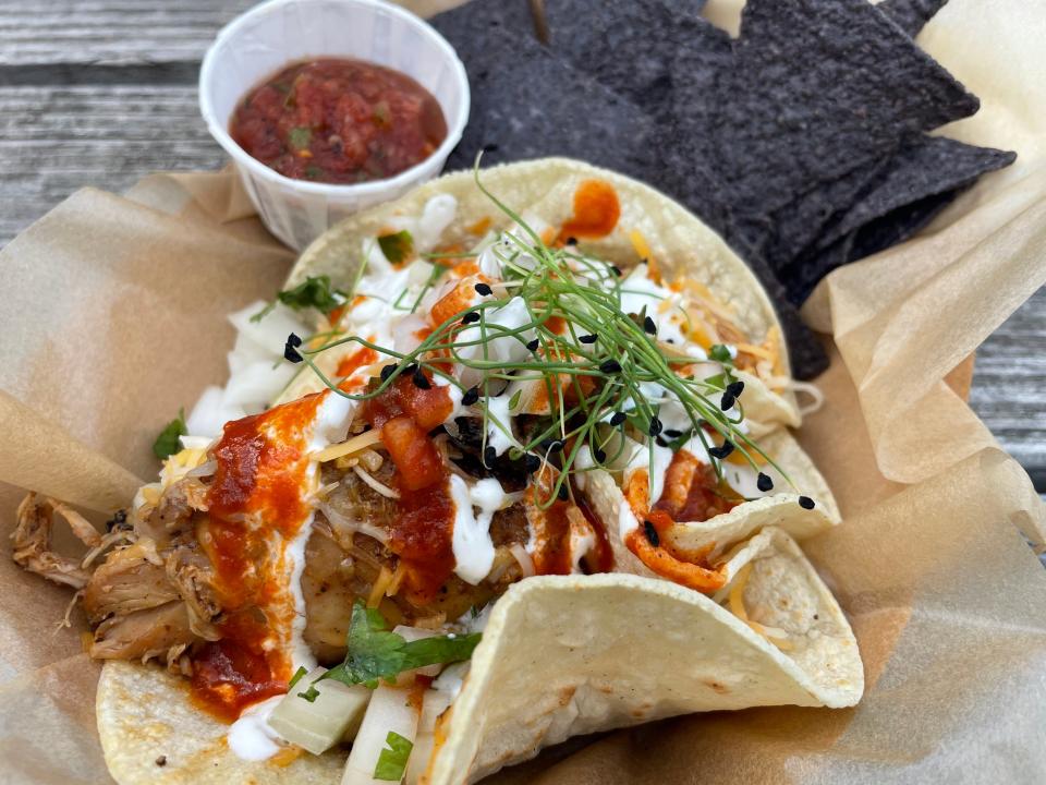 The menu at the Mustard Seed food truck emphasizes Mexican cuisine, with from-scratch items that include a burrito and nachos. The dish here is made with chicken and Hatch chile sauce.