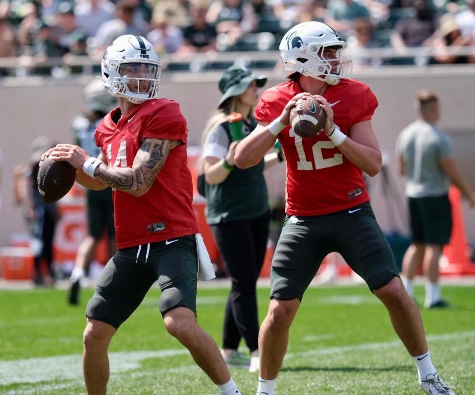 Michigan State quarterbacks Noah Kim, left, and Katin Houser, right, take part in a drill during MSU's open spring practice Saturday, April 15, 2023 at Spartan Stadium.