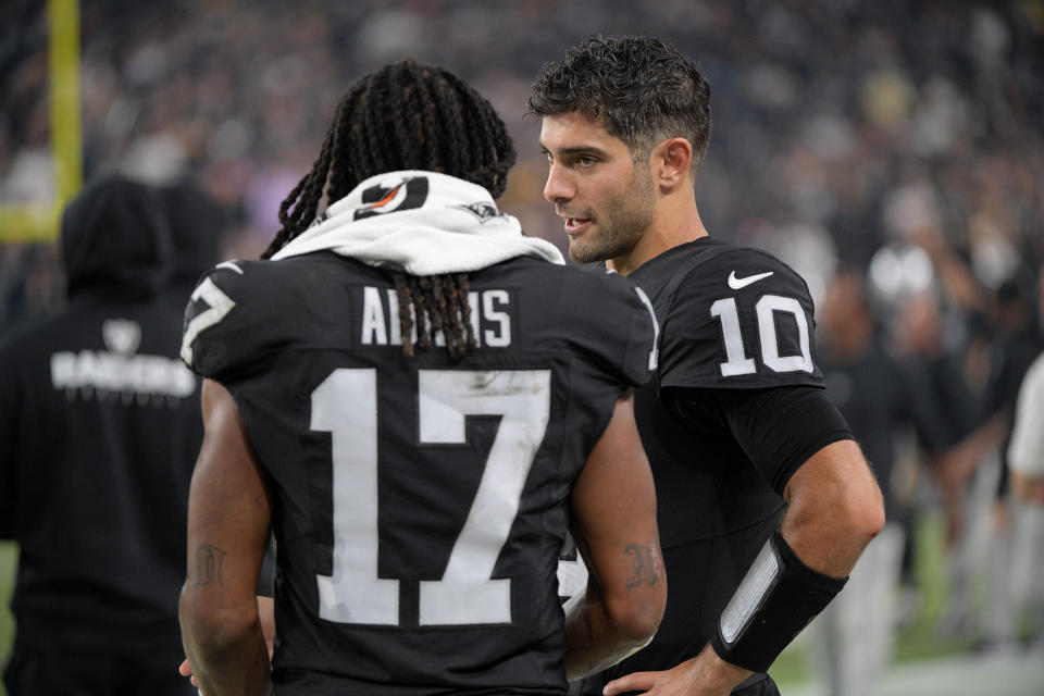 Jimmy Garoppolo #10 of the Las Vegas Raiders talks with Davante Adams