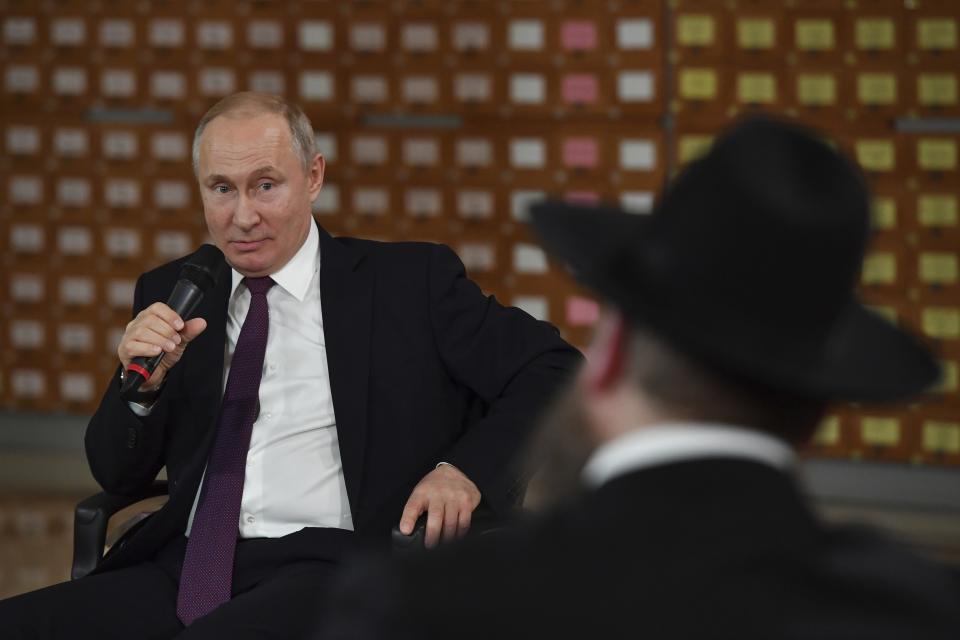 Russian President Vladimir Putin speaks during a meeting with local residents in Simferopol, Crimea, Monday, March 18, 2019. Putin visited Crimea to mark the fifth anniversary of Russia's annexation of Crimea from Ukraine by visiting the Black Sea peninsula. (Yuri Kadobnov/Pool Photo via AP)