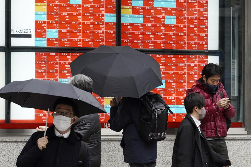 A person watches an electronic stock board showing Japan's Nikkei 225 index at a securities firm Tuesday, Jan. 24, 2023, in Tokyo. Stocks were higher in Asia on Tuesday after a tech-led rally on Wall Street as investors bet the Federal Reserve will trim its rate hikes to tamp down inflation. (AP Photo/Eugene Hoshiko)