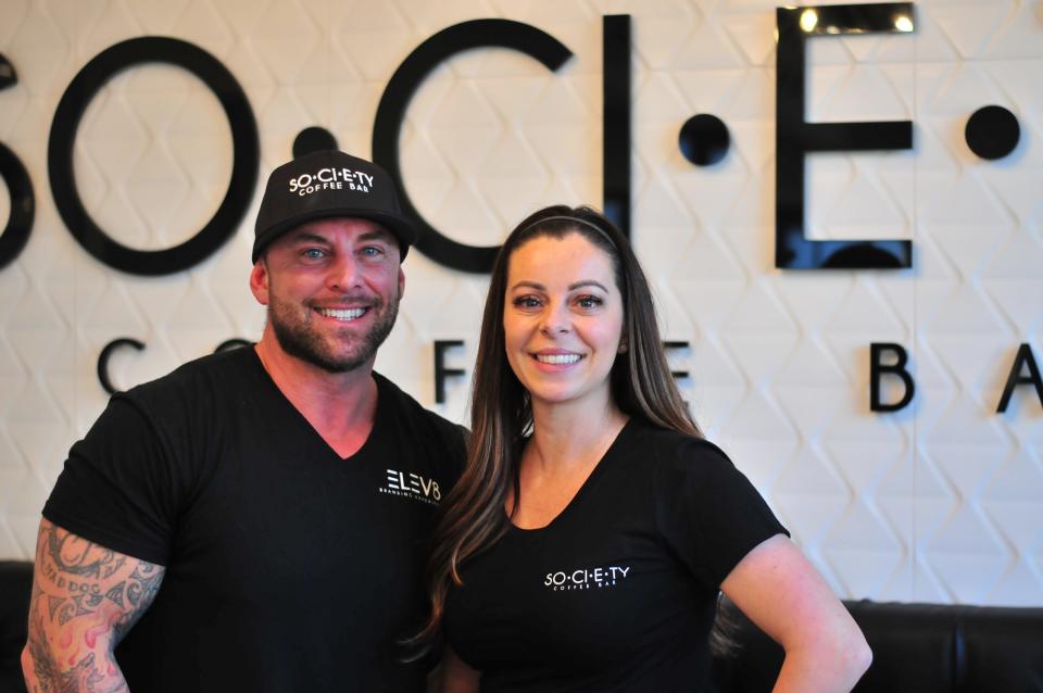 Keith and Debra Viveiros pause for a photo in their newly opened coffee shop, Society Coffee Bar at 260 Broadway in Taunton, on Monday, Jan. 10, 2022.