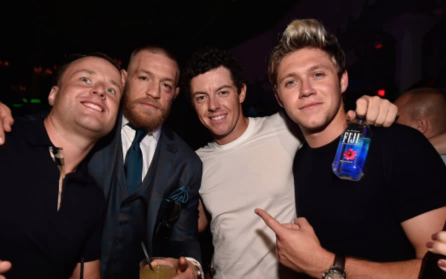 Rory McIlroy (centre right) celebrates with Conor McGregor after his UFC 202 victory - Instagram 