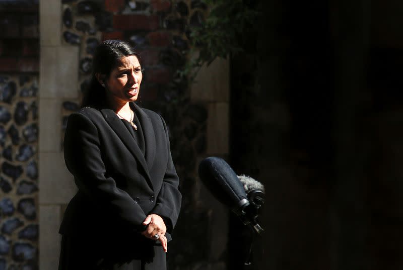 Britain's Home Secretary, Priti Patel, speaks to the media near to the scene of reported multiple stabbings in Reading