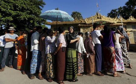 A muslim voter lines up to vote in a Buddhist prayer hall during the general election in Mandalay, Myanmar, November 8, 2015. REUTERS/Olivia Harris