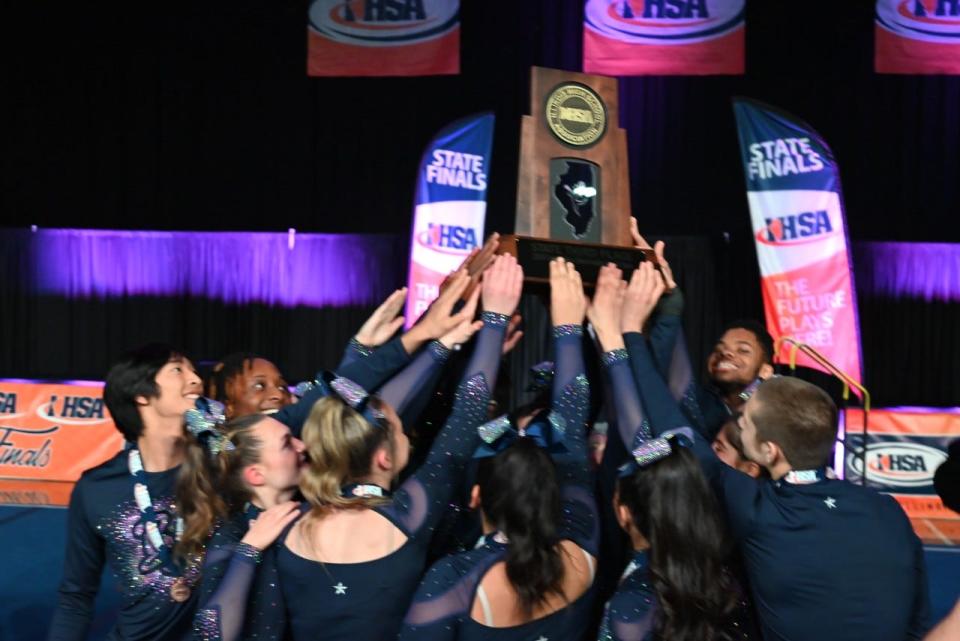 The Belvidere North Blue Thunder cheerleading team holds onto its third-place trophy after returning to the podium at the IHSA state tournament on Saturday, Feb. 3, 2024, in Bloomington.