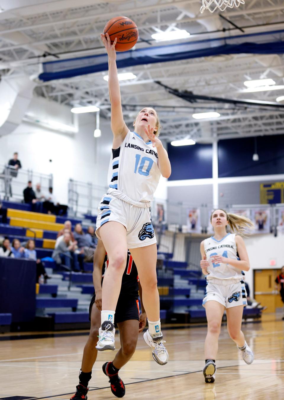 Lansing Catholic's Anna Richards goes up for a fast-break layup against Redford Westfield Prep, Tuesday, March 14, 2023, at Chelsea High School. Lansing Catholic won 78-69.