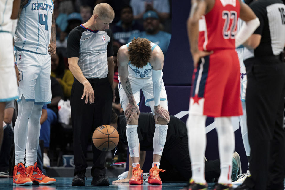 Charlotte Hornets guard LaMelo Ball is shaken up on a play in the second half of an NBA preseason basketball game against the Washington Wizards in Charlotte, N.C., Monday, Oct. 10, 2022. (AP Photo/Jacob Kupferman)