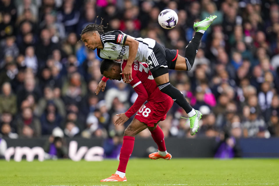 Fulham's Bobby Decordova-Reid, top, duels for the ball with Liverpool's Ryan Gravenberch during the English Premier League soccer match between Fulham and Liverpool at Craven Cottage stadium in London, Sunday, April 21, 2024. (AP Photo/Kirsty Wigglesworth)